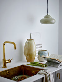 Sculptural stone magazine rack styled in Nordic minimalist living room