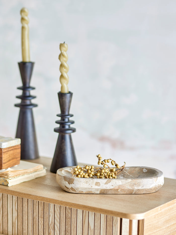 Neutral marble tray styled with candles and gold accents on oak surface