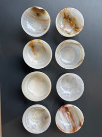 Selection of miniature onyx marble bowls with cream and amber veining all very different from the next