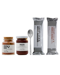Contents of the Nicolas Vahé Double Dipper gift bag: BBQ spices, Arrabbiata pesto, silver-finish spoon and two bags of potato crisps