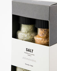 Close-up of the Nicolas Vahé Parmesan and basil and chilli salt grinders inside the gift box