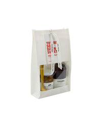 Nicolas Vahé You're So Damn Sweet white windowed gift bag with red hang tag, jam and caramel syrup inside