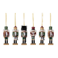 Six hand-painted wooden nutcracker Christmas ornaments in green, red, and gold