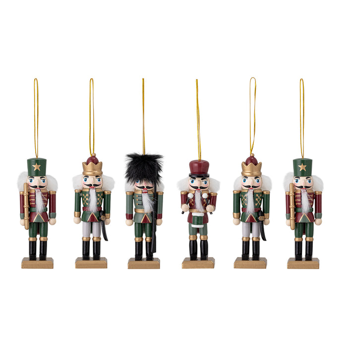 Six hand-painted wooden nutcracker Christmas ornaments in green, red, and gold