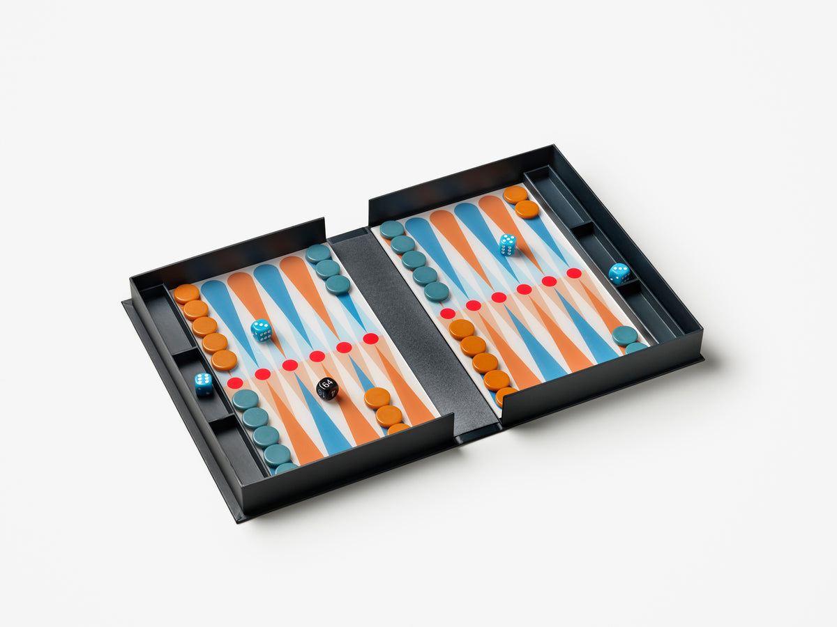 Open backgammon game board with orange and blue pieces on white surface