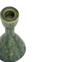 Close-up of the Oto candle holder's top and yellow-flecked green glaze