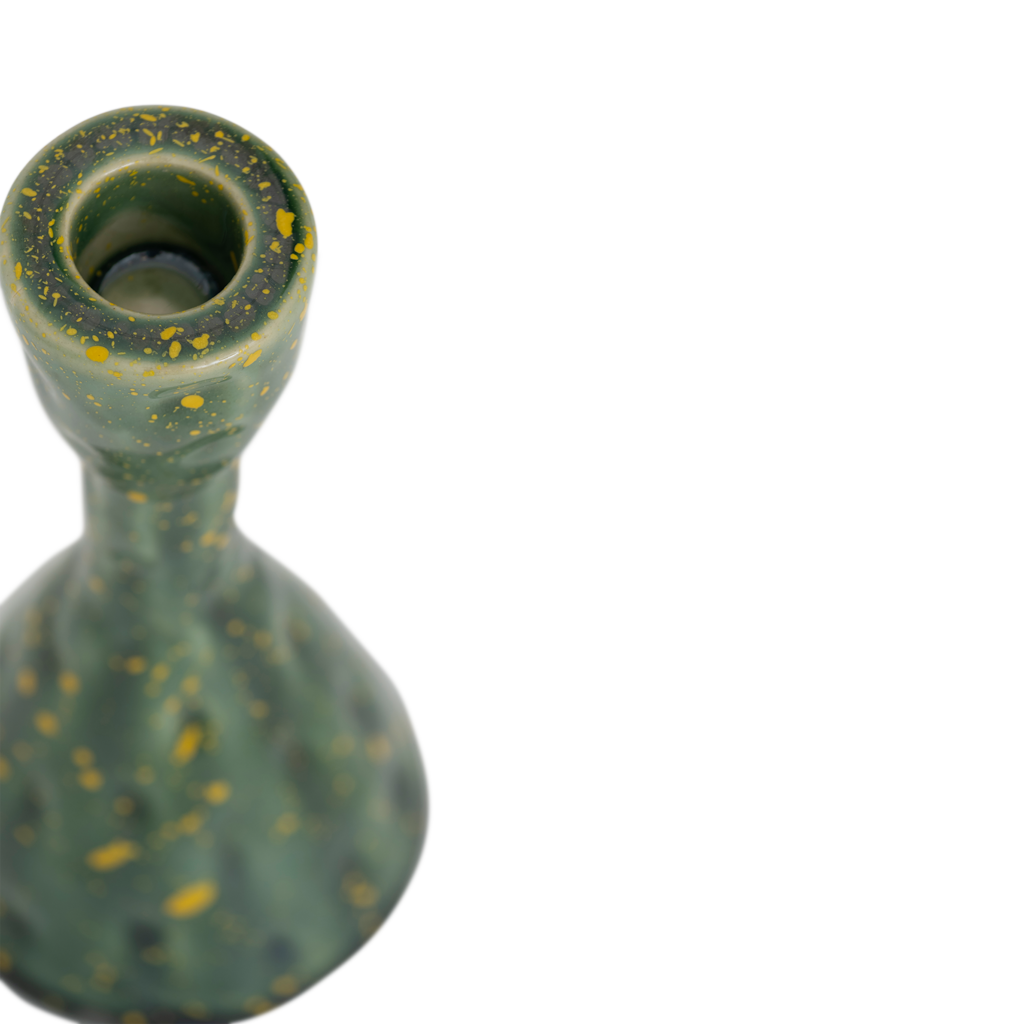 Close-up of the Oto candle holder's top and yellow-flecked green glaze