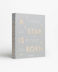 angled view of Printworks A Star Is Born baby album in grey

