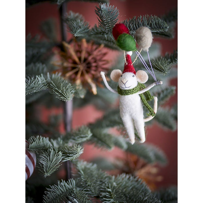 Felt wool mouse ornament with red hat and green scarf holding balloons on a Christmas tree