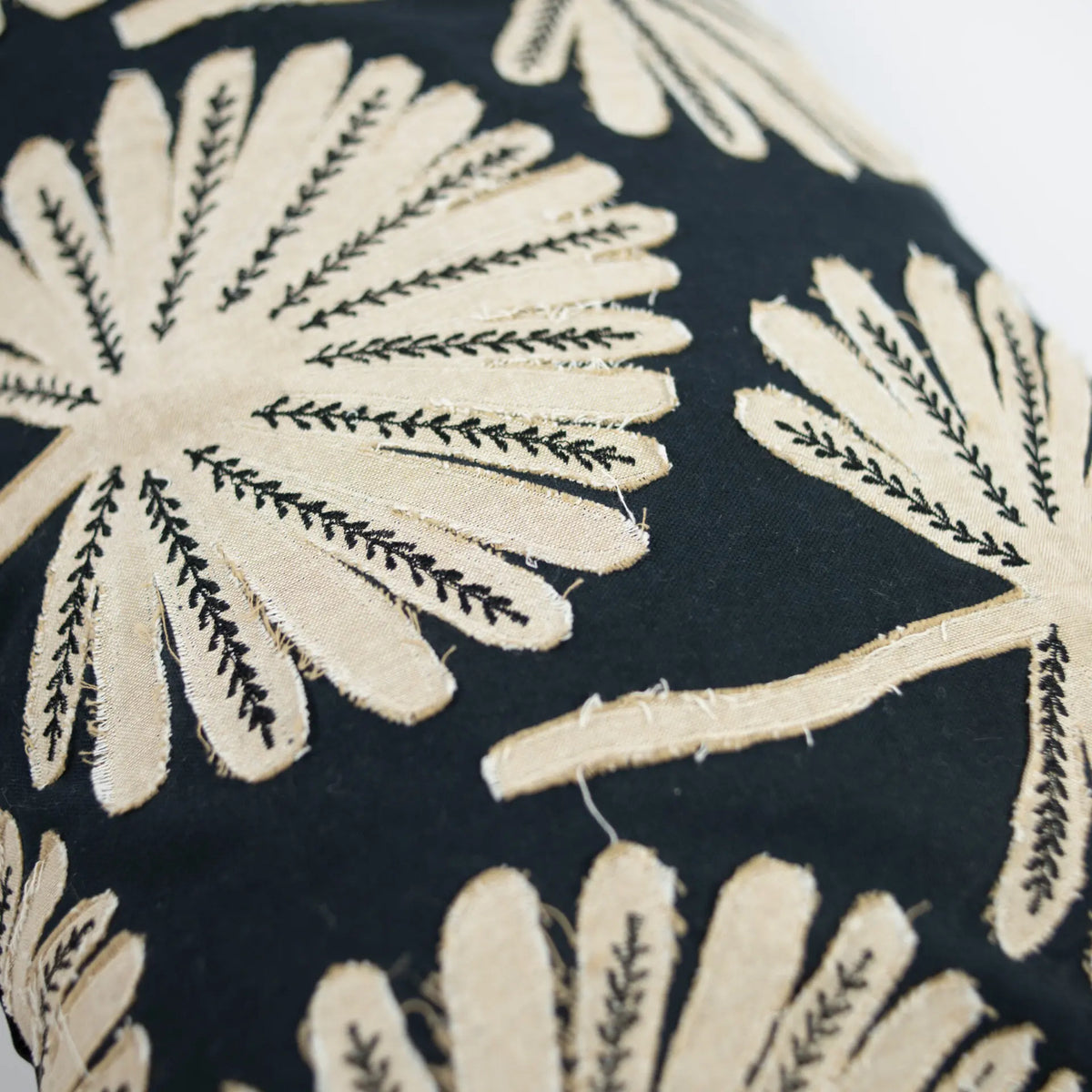 Close-up of the cream palm design on the Phoenix cushion by Olsson & Jensen
