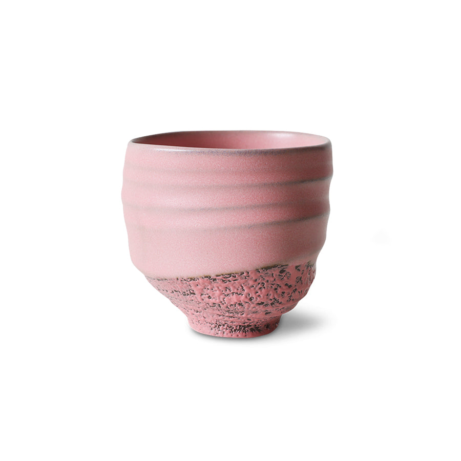 Handleless pink stoneware cup with gentle throwing rings and unique variations.
