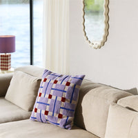 Plano cushion on a cream sofa in a bright living room