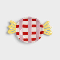 Candy-shaped dish with red and white checkered design on a light gray background