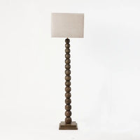Preston turned wooden floor lamp by Olsson & Jensen, shown with a linen shade