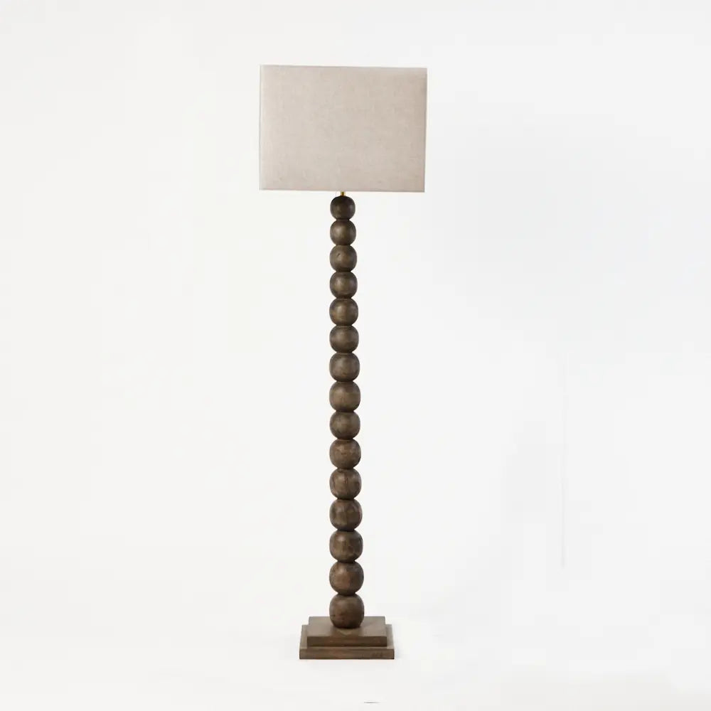 Preston turned wooden floor lamp by Olsson & Jensen, shown with a linen shade