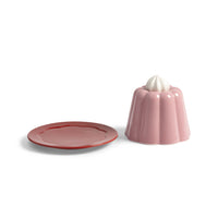 Pink pudding cloche dome and red plate shown side by side