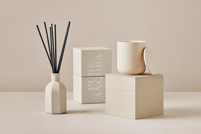 Pure Angora ceramic candle with matching gift box and reed diffuser in soft neutral tones

