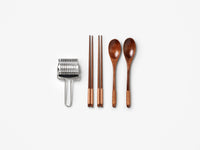 Wooden spoons and chopsticks with stainless steel noodle cutter