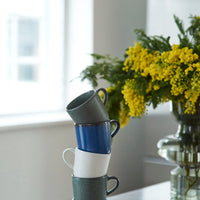 stacked RAW coffee cups by aida in northern green blue white and brown