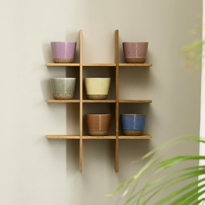 RAW Colour mugs by aida in mixed colours styled on a wall shelf