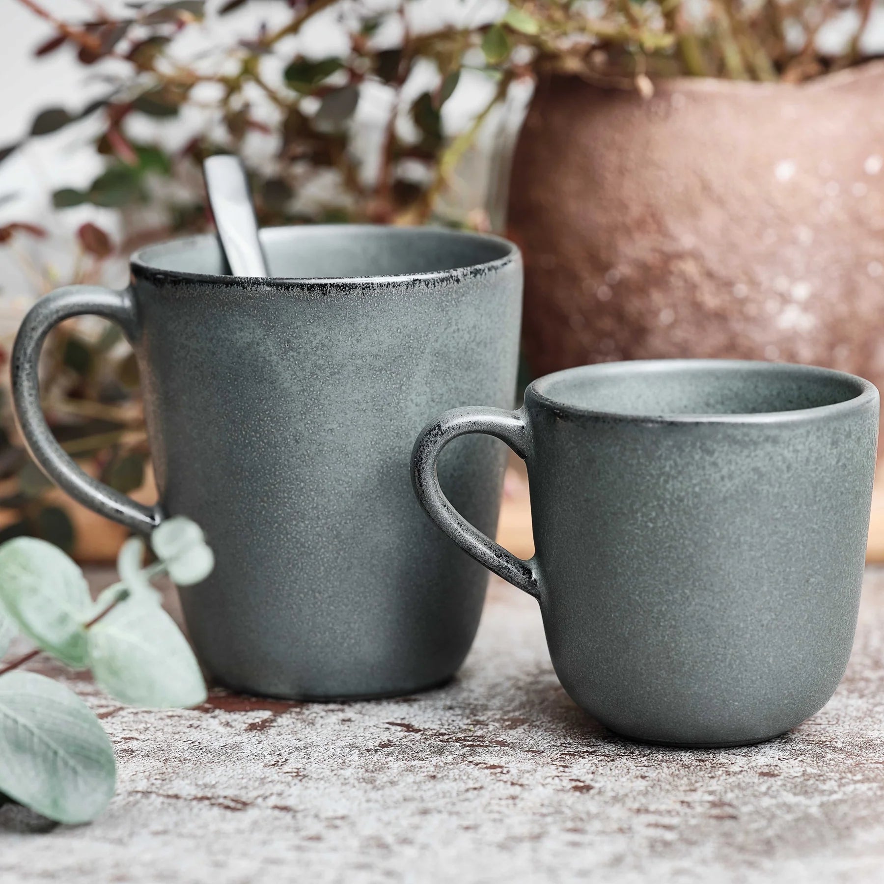 RAW northern green coffee cup by aida styled beside a matching mug