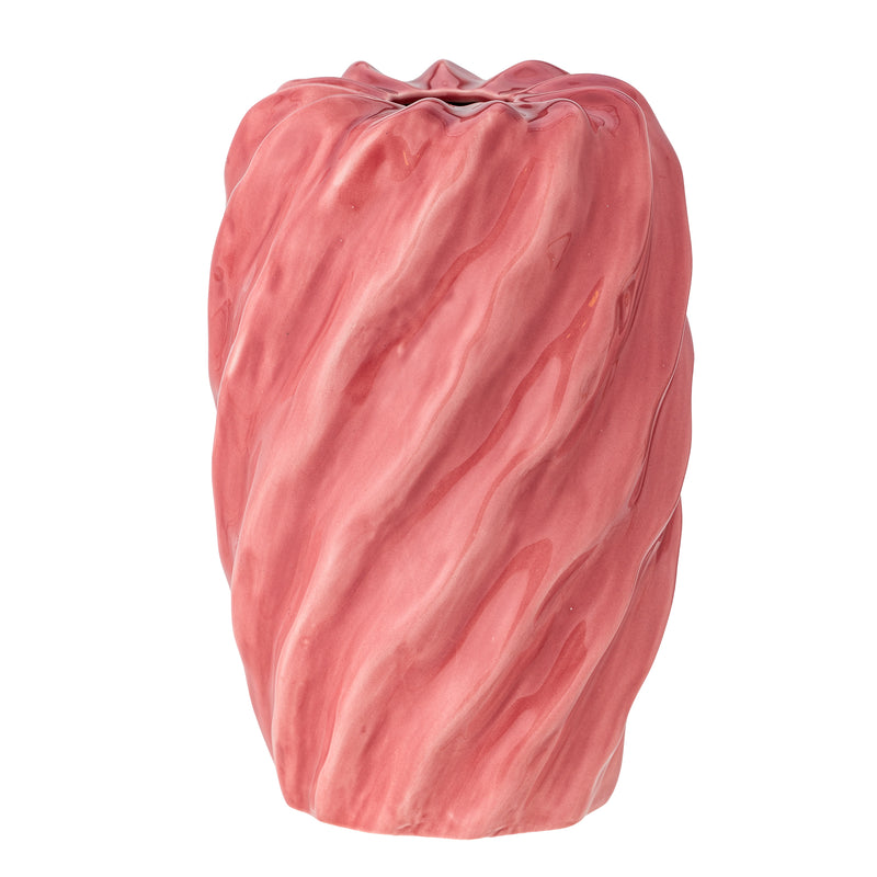 Close-up of pink twisted ceramic vase showing wavy surface and glossy glaze