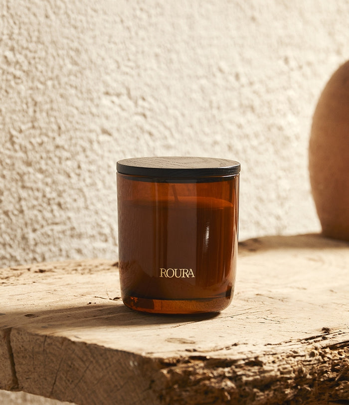 Royal Amber scented candle in amber glass with black lid, single wick design