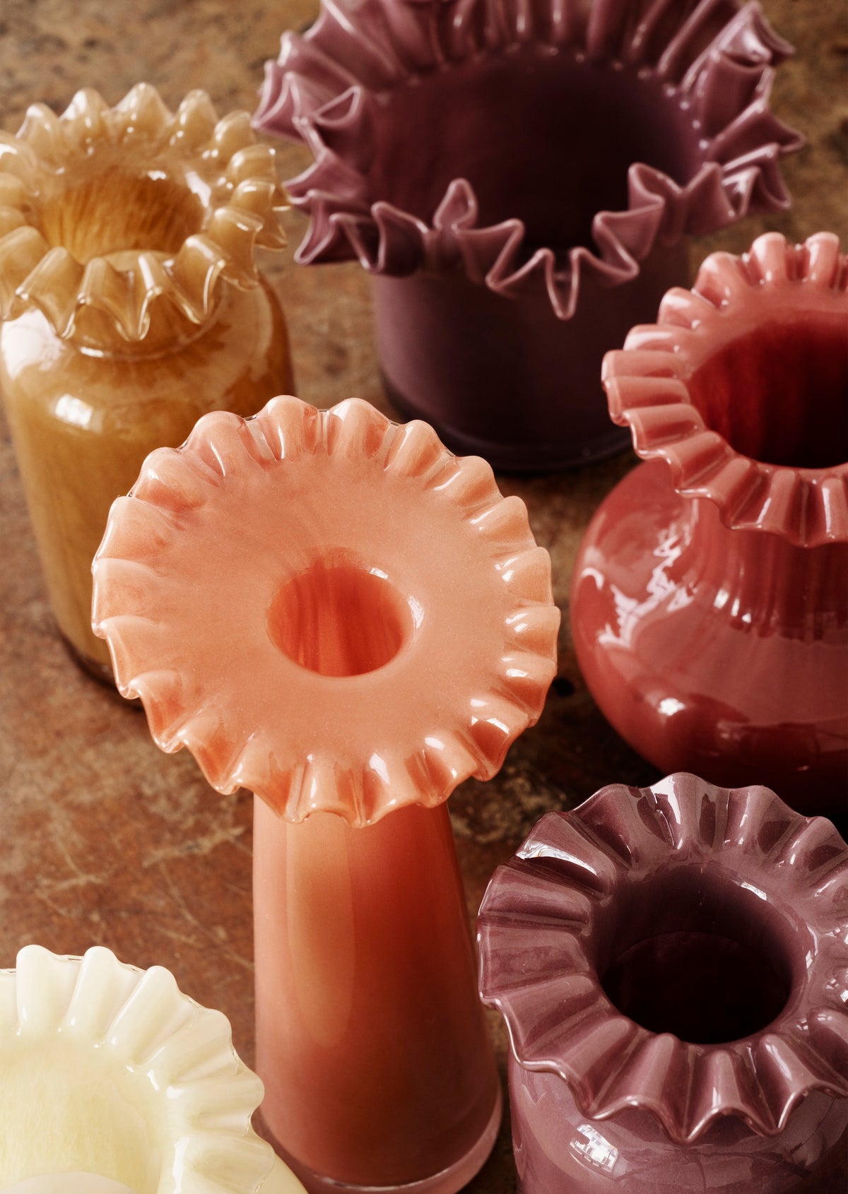 collection of ruffle edge glass vases and pots in assorted colours

