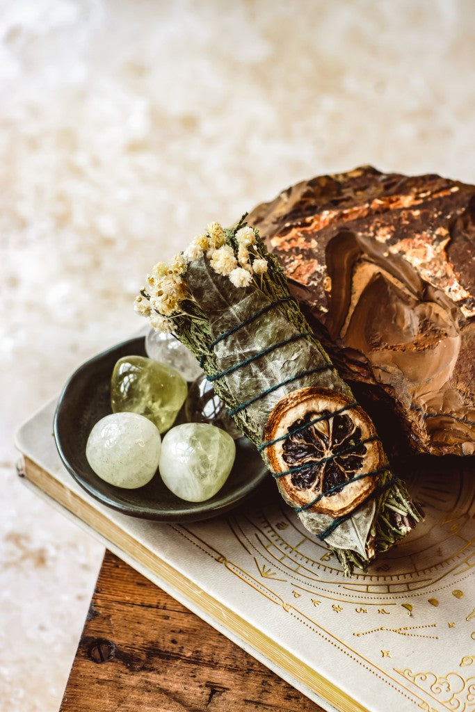 Herbal smudge bundle with dried orange slices and bay leaves