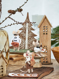 Felted wool Christmas mice with pretzel, bread, and bottle accessories styled with wooden décor