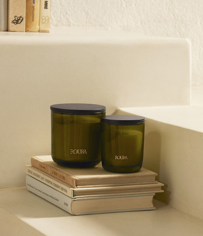 Secret Garden scented candles with black lids, olive green glass vessels