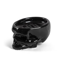 Side profile of glossy black skull soap tray showing drainage ridges
