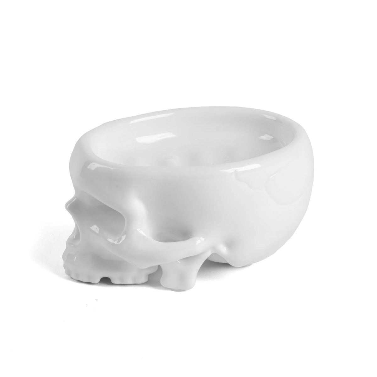 Glossy white skull-shaped soap dish with inner drainage ridges.
