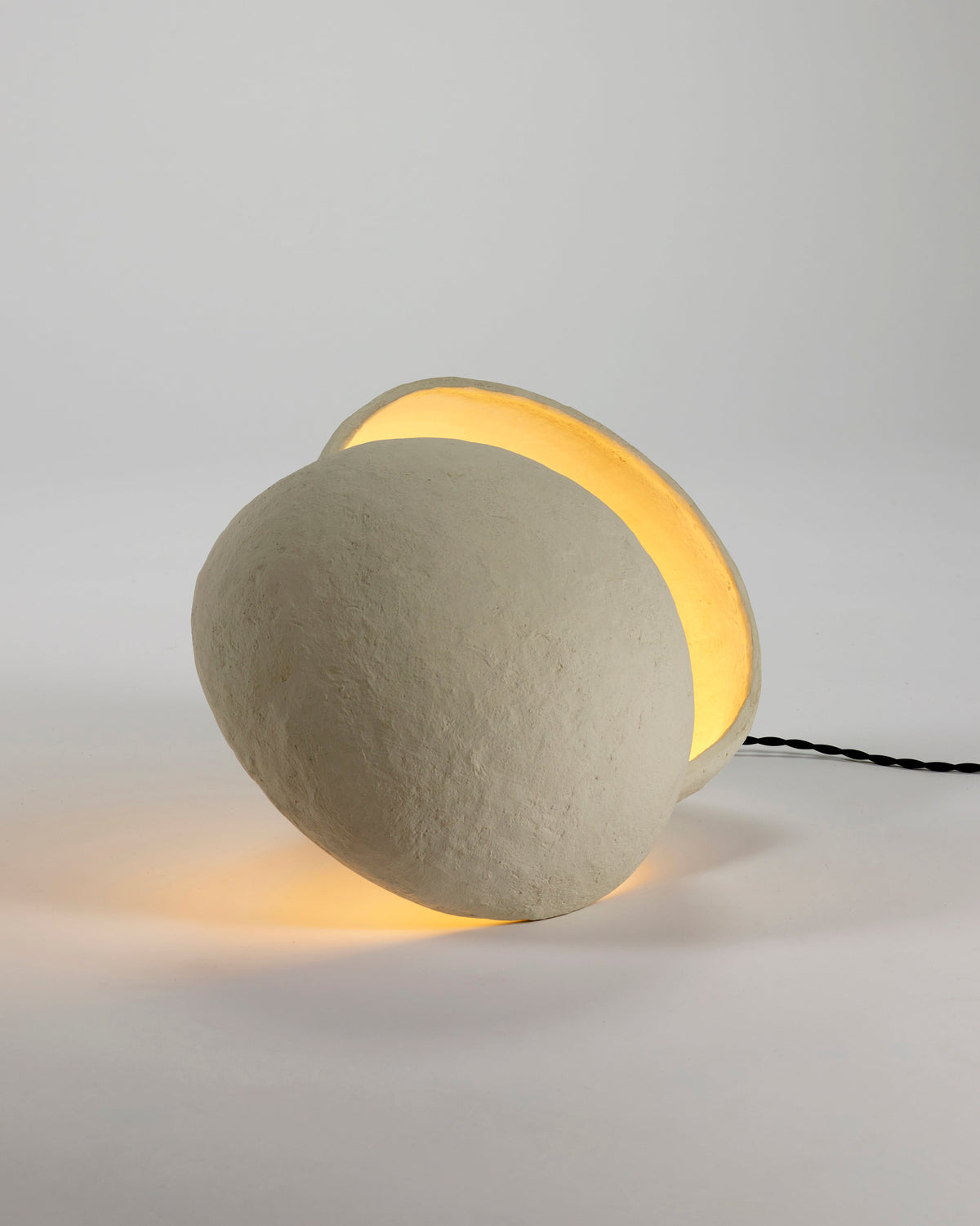 Close view of the Earth paper mâché lamp by Serax showing the textured surface and hidden light