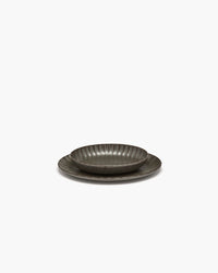 Side view of the green Inku oval serving bowl by Serax