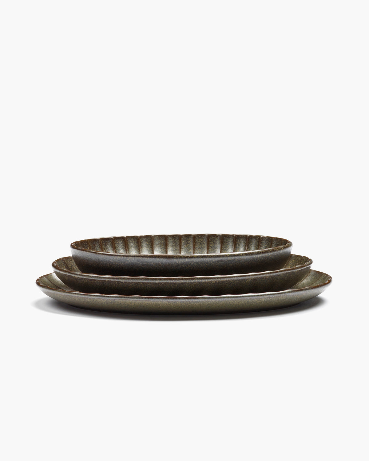 Stacked green Inku oval serving bowls by Serax