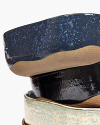 Stack of blue Merci No.6 extra deep plates by Serax showing the speckled glaze