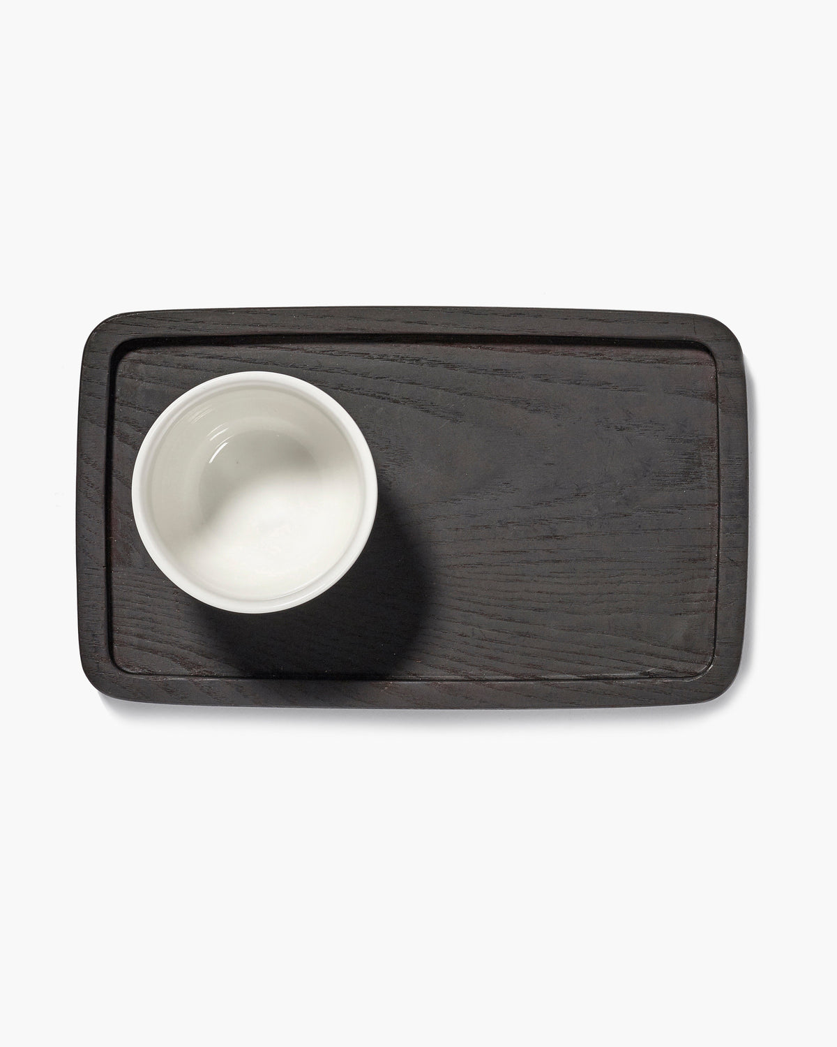 Serax Passe-partout carbonised ash tray holding a white cup