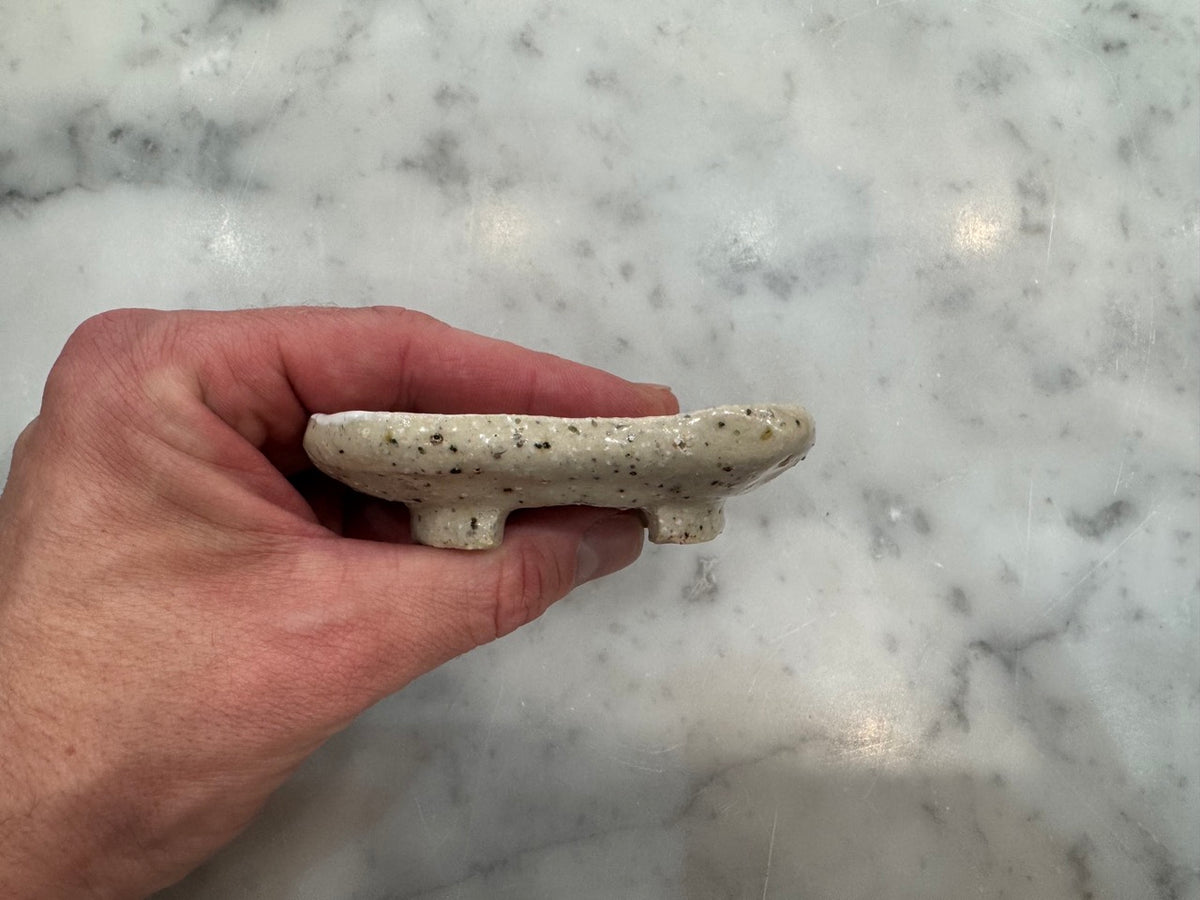 Side profile of square footed ceramic soap holder to prevent soggy bars