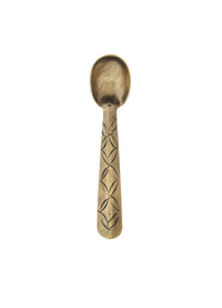 Small antique brass spoon with etched handle on white background