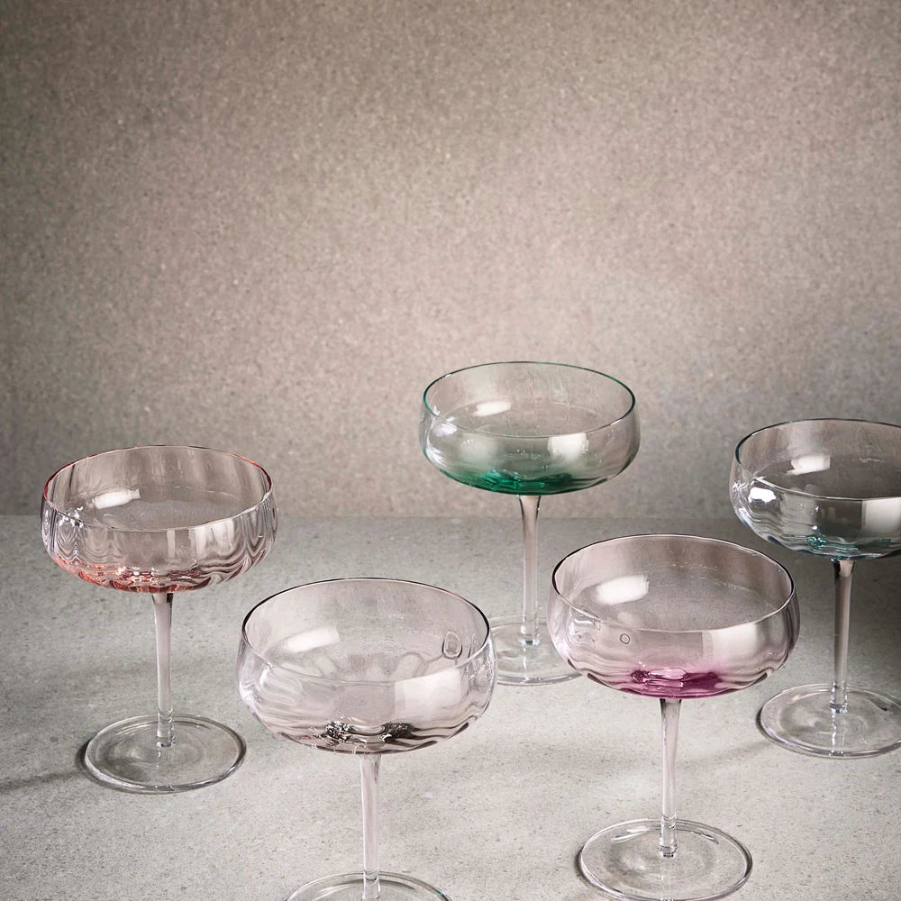 Set of colorful glass cocktail glasses from Aida SØHOLM Sonja collection on a neutral background