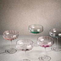 Set of colorful glass cocktail glasses from Aida SØHOLM Sonja collection on a neutral background
