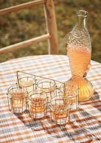 clear fish glass decanter styled on a summer table with drinks
