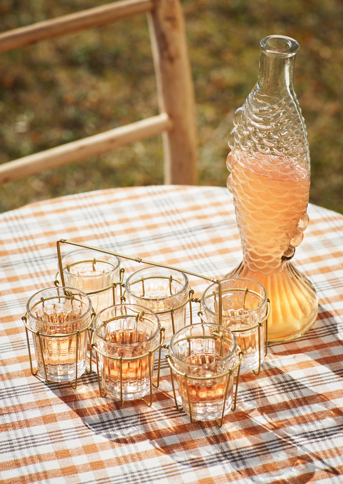 clear fish glass decanter styled on a summer table with drinks