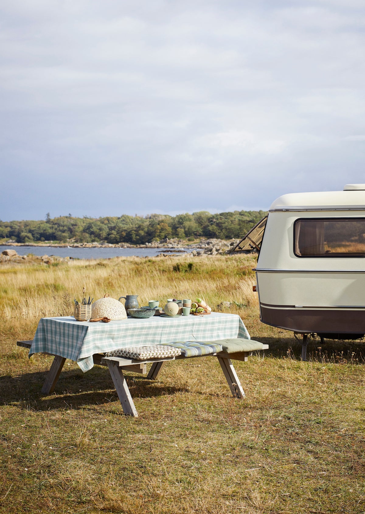petrol green stoneware serving bowl styled on outdoor picnic table
