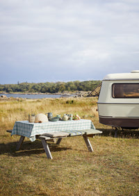 petrol green stoneware serving bowl styled on outdoor picnic table

