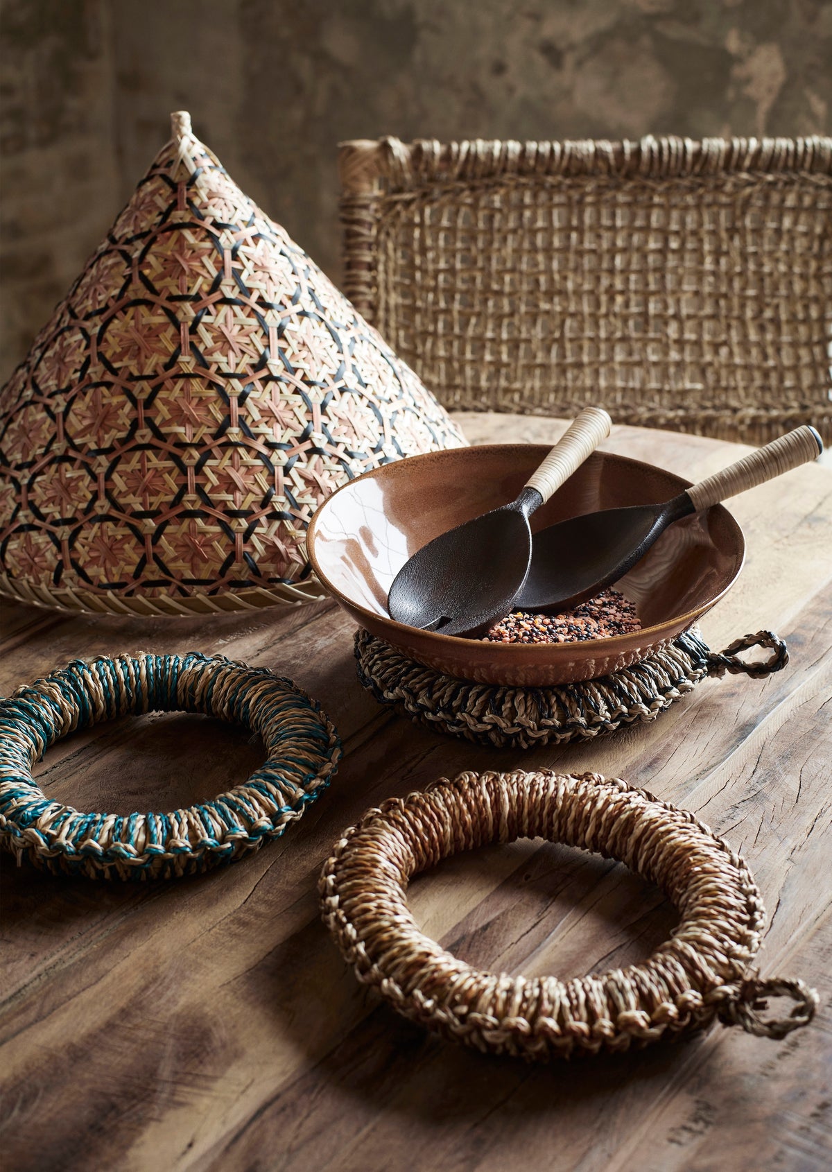 wooden serving set with bamboo handles styled in a ceramic bowl on a rustic wooden table
