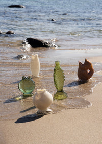 fish-shaped glass vases styled by the sea for coastal interior inspiration
