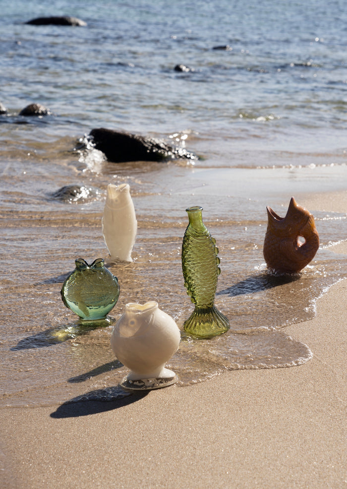 fish-shaped glass vases styled by the sea for coastal interior inspiration
