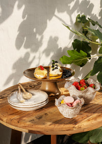 beige and brown matching speckled stoneware plates and bowls styled together
